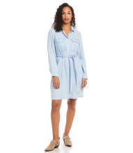 Load image into Gallery viewer, A gorgeous soft and lightweight fabrication shapes an effortlessly feminine shirtdress.  Detailed with patch pockets, matching self-tie belt and cinched waist, our Campbell dress is a fashionable look that can easily transition from season to season. Wear with sandals in the summer or pair with your favorite leggings and boots in the winter.    Color- Chambray. Chest pockets and side pockets. Button down. Self-tie belt.
