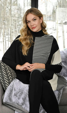 A gorgeous and stylish sweater, our Charisma with color blocking in off-white and black along with a panel of houndstooth, is an incomparable fashion design.  Our sweater is designed with dolman sleeves and includes a flattering, generous cut.  Color- Black, off-white. Unlined. Dolman sleeve. Approximately 30 inches long, with a 24 inch sleeve.