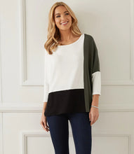 Load image into Gallery viewer, Our Darcy dolman top has colorblock panels that flatter your figure while offering a fabulous modern touch. The dolman sleeves and relaxed top offers a generous fit that creates an ultra-comfortable top to wear.  Pairs wonderfully with denim, black or white bottoms. Color- Colorblock in white, black and olive. Three quarter sleeves. Dolman sleeves. Relaxed, generous fit.

