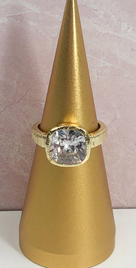 Sparkle galore describes this fabulous square cut cubic zirconia ring.  A brilliant gold band with a unique finish, adds to the beauty.  A ring for all occasions, this statement piece will definitely get noticed!