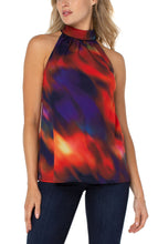 Load image into Gallery viewer, Showcasing brilliant color in an unique northern lights print, this top is perfect for brunch or special occasions. Pair it with denim or a trouser. This amazing style will is a definite attention grabber!  Colors- Splashes of red, purple/blue, yellow. Mock neck/halter. Button closure. Double layer.
