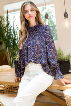 Load image into Gallery viewer, A beautiful, delicate floral pattern sits atop a navy background on our gorgeous Amanda top.  A lovely smocking found around the chest and back and just above the wrist, creates a romantic appearance while the slight ruffle sleeve at the wrist below the smocking, gives the top a feminine flair.  The beauty of this top is enhanced by the flowy, lightweight fabric.  Dress up for a night out, or for work or pair with your favorite shorts or jeans for a casual feel.
