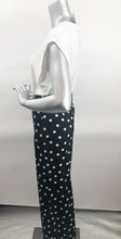 Load image into Gallery viewer, Create a fashionable look with our black and white polka dot pant designed by Frank Lyman.  A perfect pant for the summer season, just pair it with one of our white or black tops and you will be a fashionista ready to seize the day.  A perfect pant to travel with as it does not wrinkle!
