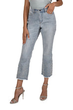 Load image into Gallery viewer, Classic bling detailing creates a stunning light blue denim crop pant by Frank Lyman.  A mixture of oval crystals and white faux pearls are offset with smaller silver crystals at the bottom of each pant leg.  A slight fray at the hems, give this beautiful pant a bit of extra edge!  Beautifully pairs with so many tops, this extraordinary denim pant is a must have in your closet!

