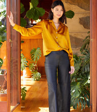 Load image into Gallery viewer, Cut from luxurious heavy satin, this top is ultimate sophistication. A perfect top to dress up or down, it easily pairs with skirts, slacks or denim.  Wear open with our Gabriela Gold Satin Drape Cami for an elevated look. Color- Gold Long sleeve with button cuff. Button down Vintage satin Fabric-100% Polyester.
