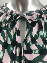 Load image into Gallery viewer, A darling short sleeve top, our Betsy has an incredible abstract print in pink, green, black and white.  The details on this fabulous top give it an edge with ruffle sleeves and a ruffle v-neckline with ties. Our Betsy pairs beautifully with black or white bottoms.   Colors- Light pink, green, black and white. Pull-over. Ruffle detailing on sleeves and neckline. V-neck. Ties. Abstract print. Not sheer. Not stretch fabrication.
