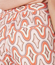 Load image into Gallery viewer, Our Gloria wide leg pant is just &quot;groovy&quot; with its 70&#39;s inspired geometric print. These cool pants have side pockets and a blind zipper on the side and have a terrific satin feel.  Looks fantastic paired with our BRITTANY BRIGHT PEACH PUFF SLEEVE TOP - ESQUALO and our ODELIA OFF-WHITE BLOUSON SLEEVE T-SHIRT - ESQUALO.  Color - Groovy; Coral, peach, off white, light brown, light yellow. Geometric print. Lined. Satin feel fabric. Not a stretch fabrication. Side zipper closure. Wide leg design.
