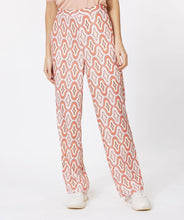 Load image into Gallery viewer, Our Gloria wide leg pant is just &quot;groovy&quot; with its 70&#39;s inspired geometric print. These cool pants have side pockets and a blind zipper on the side and have a terrific satin feel.  Looks fantastic paired with our BRITTANY BRIGHT PEACH PUFF SLEEVE TOP - ESQUALO and our ODELIA OFF-WHITE BLOUSON SLEEVE T-SHIRT - ESQUALO.  Color - Groovy; Coral, peach, off white, light brown, light yellow. Geometric print. Lined. Satin feel fabric. Not a stretch fabrication. Side zipper closure. Wide leg design.
