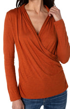 Load image into Gallery viewer, This long sleeve slub knit top features a wrap front for a truly flattering fit. Easy enough to lounge around the house in, chic enough to wear out in the city.   Michelle is modeling the Henna top in the last photo.  She has this lovely top paired with our Fay Faux Leather pant.    Color- Henna; reddish brown. Long sleeve Wrap front
