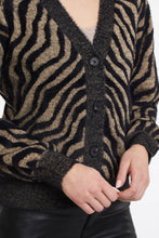 Load image into Gallery viewer, Animal print is here to stay. We are loving the dynamic zebra print in a black and tan combination. The ultra-soft feather knit on this gorgeous cardigan will provide you all day comfort and endless style!  Color- Black and tan. Button-front V-neck. Relaxed fit. Contrast placket, hem, and cuffs. Feather sweater yarn.
