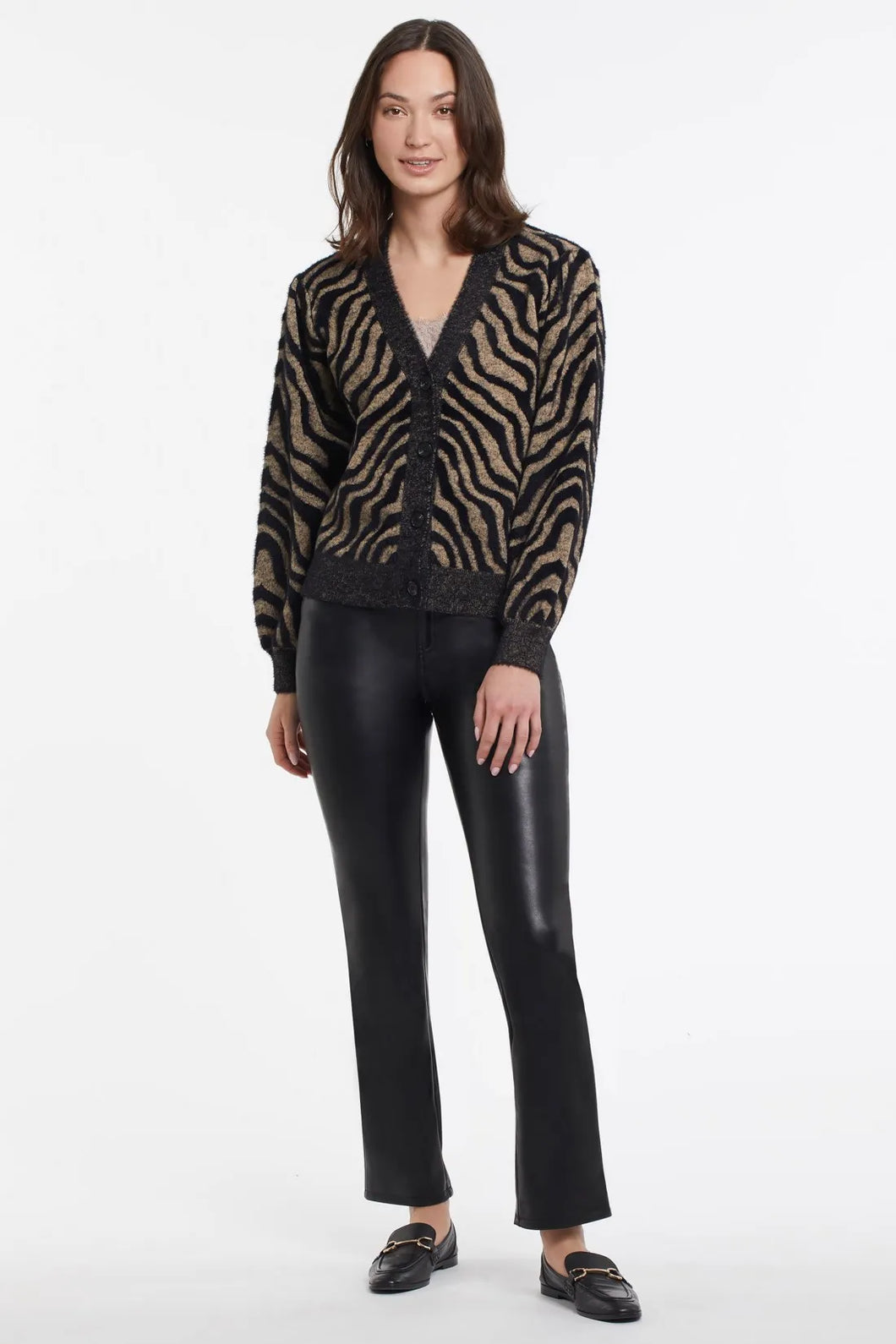 Animal print is here to stay. We are loving the dynamic zebra print in a black and tan combination. The ultra-soft feather knit on this gorgeous cardigan will provide you all day comfort and endless style!  Color- Black and tan. Button-front V-neck. Relaxed fit. Contrast placket, hem, and cuffs. Feather sweater yarn.