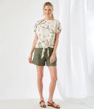 Load image into Gallery viewer, Tie dye is all the rage and our Penny top by Karen Kane is all the fashion with its cloudy tie dye pattern in pale pink and light olive. Cinched at the waist for a figure-flattering fit, this jersey-knit top features a sleek boat neckline, drop shoulder sleeves, and stylish tie-front. A perfect top for the season, pair with your favorite shorts or jeans for a stylish outfit! Color- Tie dye in pale pink and light olive.
