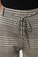 Load image into Gallery viewer, Preppy printed jacquard gets an athleisure-inspired refresh with the addition of a charming tie front with belt loops. A light dusting of gold sparkle thread elevates this fashionable pant. Comfortable and chic, this pant is the best of both worlds.  Pairs perfectly with our BIANCA BEIGE AND BLACK KNIT JACKET- JOSEPH RIBKOFF 223298 Color- Beige, black, gold and just hints of yellow and dark orange. Elastic waist. Drawstring. Belt loops and self-tie.
