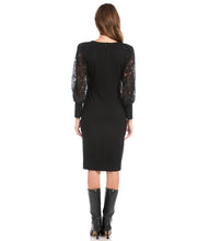 Load image into Gallery viewer, This stunning black dress is elevated to a whole new level with beautiful airy lace sleeves. This curve-defining dress is cut from soft jersey-knit for a comfortable, evening look. Pair with tall black boots or your favorite pair of heels. Color- Black. Blouson lace sleeve. Center back invisible zipper. Sheath silhouette. V-Neck.
