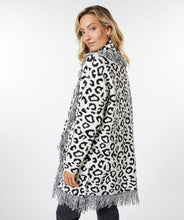 Load image into Gallery viewer, An amazing all over leopard print in black and off-white creates a stunning cardigan. The fringe detailing and jacquard fabrication elevates this cardigan to new heights. Pairs beautifully with so many of your favorite bottoms.  Color- Black and off-white. Leopard print. Oversized fit.  Can easily size down one size. Fringe detailing. Front single hook eye closure. Two front functional pockets. Jacquard knit.
