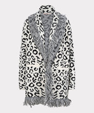 Load image into Gallery viewer, An amazing all over leopard print in black and off-white creates a stunning cardigan. The fringe detailing and jacquard fabrication elevates this cardigan to new heights. Pairs beautifully with so many of your favorite bottoms.  Color- Black and off-white. Leopard print. Oversized fit.  Can easily size down one size. Fringe detailing. Front single hook eye closure. Two front functional pockets. Jacquard knit.
