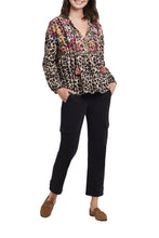 Load image into Gallery viewer, A colorful and fun pattern print comes alive on this dolman sleeve blouse. A bold abstract print combines with a leopard print to create a uniquely beautiful design. The Trisha long sleeve blouse is a perfect top to dress up or wear casually with jeans.  Any way you decide to style this gorgeous top, you will definitely stand out as a fashionista!  Color- Taupe grey, pinks, gold, red. Dolman sleeve. Self-tie at neck. Multi print. Pop-over notch neck with tassel trim. Flowy fit.
