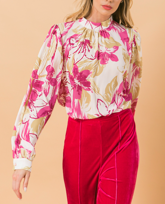 Our Ashley floral blouse is both sophisticated and fun!  A stunning abstract floral print in pink and taupe on a white base gives this blouse an edge, while billowy sleeves offer a feminine appeal.  Gathering at the collar, sleeves and shoulders add that extra flair.  Effortlessly pair this blouse with jeans for a casual look or dress up with your favorite bottoms.