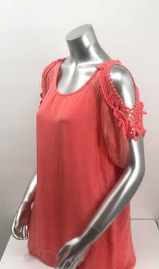 A vibrant coral color really pops on this flowy, beautiful Casey Coral Top by M Made In Italy. The design details are spectacular with crochet split short sleeves.  The flowy fabric on the outside of a solid tank offers a feminine touch.  A little drama, a little romance, this solid hue pairs perfectly with almost everything in your closet.