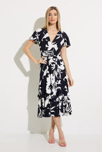 Load image into Gallery viewer, An elegant dress, our Melinda fit and flare dress is a flattering design in a brilliant midnight blue and vanilla color.  Featuring a flattering cross-over front, elastic tie waist double frill hemline and frill cap sleeves this dress has elegant movement and is attractive on all figures.
