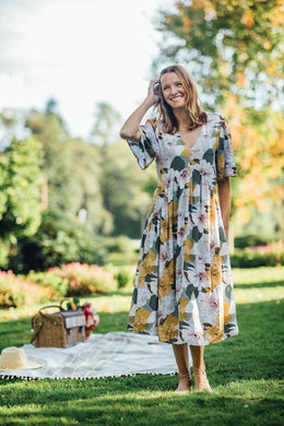 This gorgeous flowy fit dress will easily become your next favorite! A delightful mixture of colors including golden yellow, grays, greens, burgundy, pink and white come together to create a striking design. The flowy sleeves to the elbow and the tie at the waist create a romantic look that will make you feel pretty and classy at the same time.