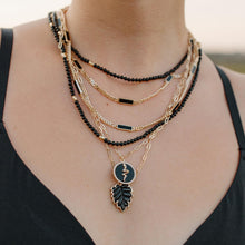 Load image into Gallery viewer, A gorgeous necklace in black onyx looks stunning with almost every outfit. Elevate your outfit with this hand-carved genuine black onyx leaf surrounded by a gold border with dainty cubic zirconia prongs.
