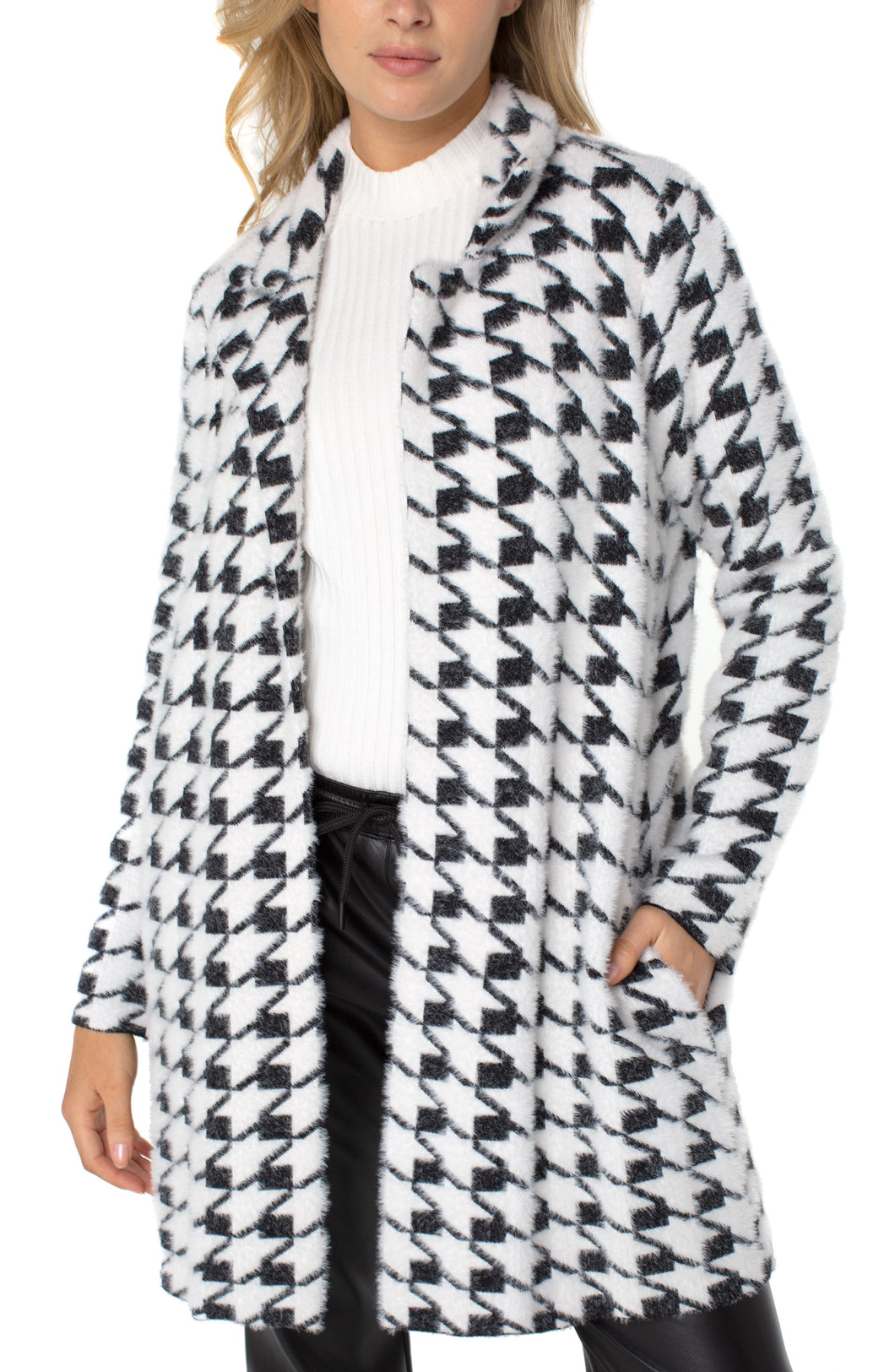 A beautiful combination of a cardigan and a coat creates a coatigan that is warm enough to wear during those cold nights but comfortable enough to wear indoors. Soft and fuzzy, you will wrap yourself in comfort each time you put on this fabulous coatigan. Featuring a beautiful black and white houndstooth pattern, this coatigan pairs well with denim, trousers or leggings!   Color- Black and white. Houndstooth pattern. Open front. Patch pockets.