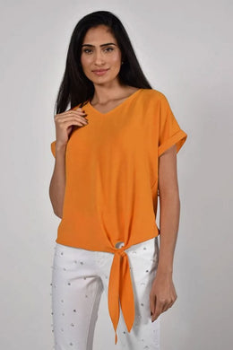 A striking orange color really pops on this lovely V-neck, tie front top by Frank Lyman.  Wear with white bottoms for a summery look or pair with black bottoms in the cooler months. Also looks fabulous with denim! 