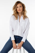 Load image into Gallery viewer, Our Odeline classic white button-down shirt is a timeless essential that needs to have a place in your closet!  A perfect style that goes from season to season, you will be amazed at the fabulous stretch on this poplin shirt!  Color- White. Button-front closure. Left front pocket. Hi-low hem detail. Wide cuff detail with button closure. May size down if in between sizes.  Fabric-65% Cotton. 32% Polyester. 3% Spandex.
