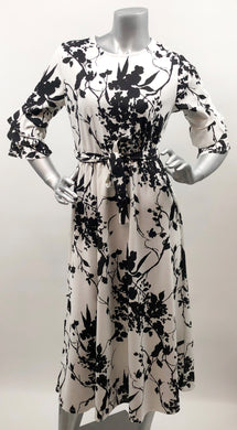 Every fabulous woman needs a black and white dress to showcase her beauty and our Vivien Black and White Floral Mid Length Dress by Papillon is the perfect dress to do just that.  Whether you are going to a garden party, a wedding or a lovely dinner, this dress will make you feel like royalty.   Colors- Black and White floral. Tie waist belt. Mid length.