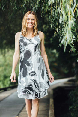 A classic dress, this black, white and gray biased cut dress will easily become your next favorite.  A lovely abstract floral pattern adorns this two-tier hem dress and with the sleeveless design, you can easily style with a cardigan or jacket.  Fully lined.