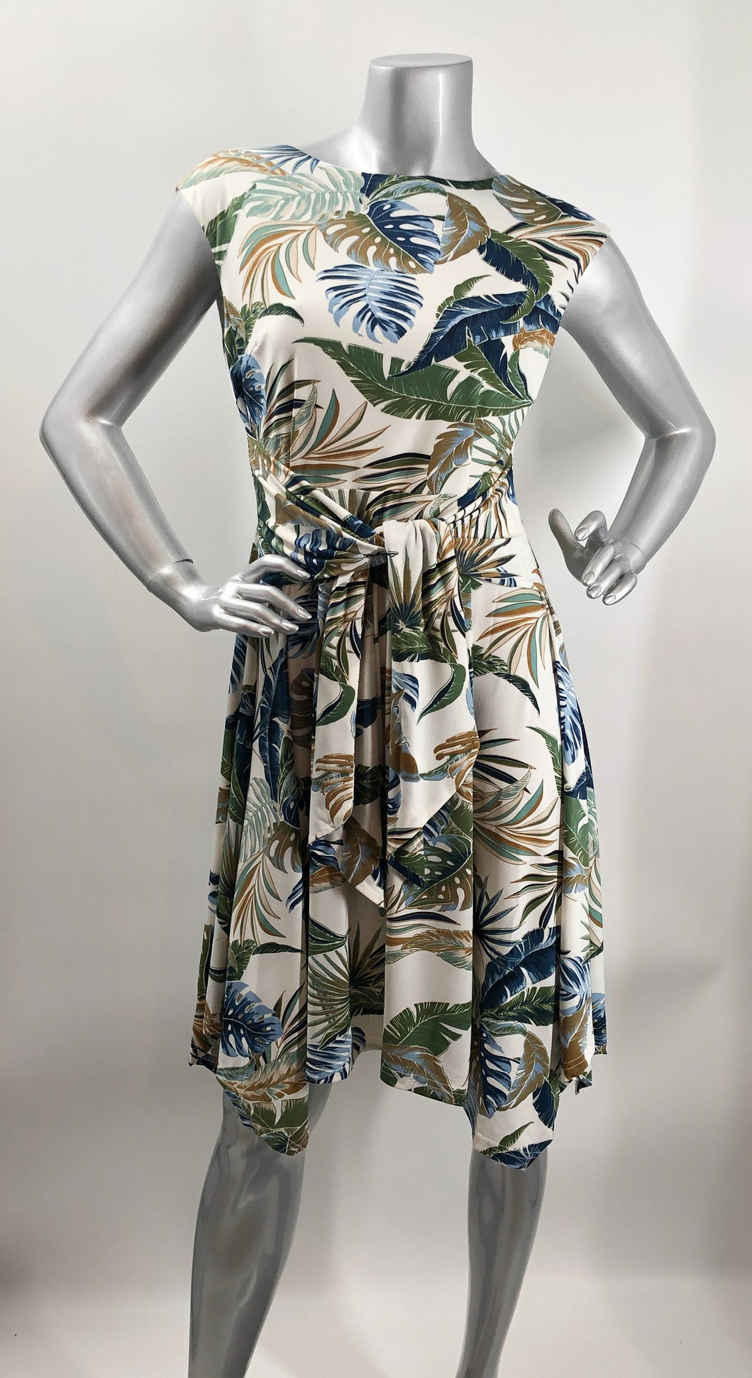 An absolutely gorgeous dress, our Winslow White Tropical dress drapes beautifully and is figure flattering.  A white background comes alive with a tropical fern print and is enhanced with a gorgeous, attached tie that can be tied in the front or back.  Worn to lunch or a night out.  This gorgeous summer dress will make a fashion statement.  