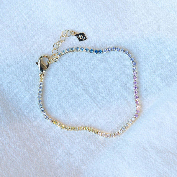 A beautiful tennis bracelet with perfect pops of pastel, the Gracie is a lovely piece that can be layered or worn alone.  Our Gracie bracelet  will easily become your new favorite for the Spring/Summer.  Add our Gracie Pastel Tennis necklace for extra sparkle!  Colors- Clear, pink, blue, yellow and gold. Length -6.5