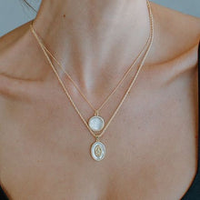 Load image into Gallery viewer, Featuring a carved mother of pearl inlay with Mary silhouette in center, this pendant is perfect to pair with the classic mother Mary necklace.  Color- Gold and white Genuine mother of pearl shell. Gold ball vermeil chain. Chain length -16&quot; + 2&quot; extender. 
