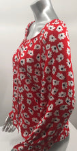 Load image into Gallery viewer, Small white flowers with black centers just pop on this gorgeous true red long sleeve top.  The feminine touches create a romantic top with a scoop neckline and a row of button closures, as well as ruffled cuffs.  A lightweight material, this will keep you cool in the warmer days and warm when there is a slight chill.  This is the choice of top to pair with crisp white bottoms and effortlessly goes well with jeans.
