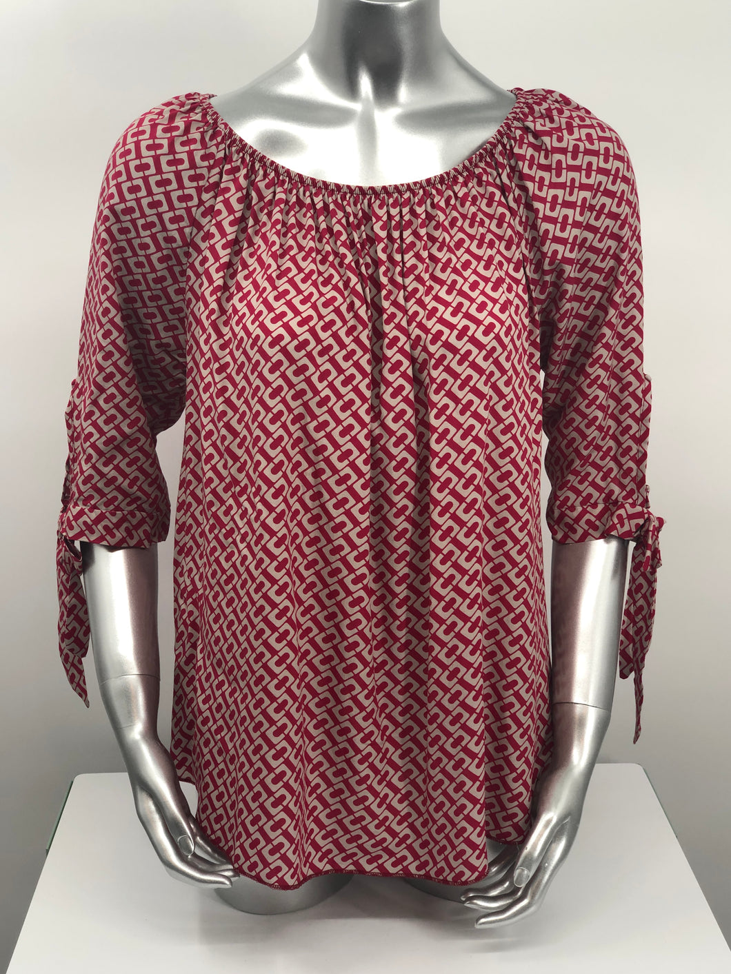 Our Rylee Raspberry Tie Sleeve Top is so versatile.  With a raspberry and tan color geometric pattern, you create so many different looks with this lovely top.  Pair with tan, white or black bottoms to create a dressier look or wear with jeans for a more casual look.  