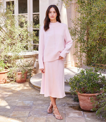 Soft and pretty, the pastel pink on this turtleneck sweater is pure perfection.  Add ribbed detailing at the collar, hem and sleeves and you have an eye-catching sweater that can go from casual to dressy.  Style with your favorite jeans or black pants or style with our PACEY PINK PLAID BIAS CUT SKIRT or our ROSE BIAS CUT MIDI SKIRT.