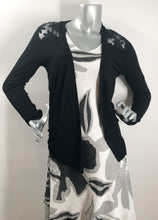 Load image into Gallery viewer, A classic dress, this black, white and gray biased cut dress will easily become your next favorite.  A lovely abstract floral pattern adorns this two-tier hem dress and with the sleeveless design, you can easily style with a cardigan or jacket.  Fully lined.
