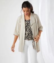 Load image into Gallery viewer, This fabulous, draped jacket in a cool and breathable linen blend, is so very versatile. It&#39;s detailed with oversized lapels and a beautiful draping for a stylish finish. A lovely piece to wear to lunch with friends or to work.  The natural color will easily pair with many of your favorite tops.  For a finished look, wear with our Cadence Pant with Drawstring in Natural Color or our Penelope Paperbag Waist Shorts in Natural Color. Color- Natural. Elbow sleeve.
