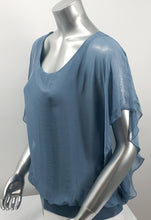 Load image into Gallery viewer, A free-flowing fabrication creates a stunning top in a slate blue color. Top is lined with a knit covered by a gorgeous silk. Bottom is banded in the same color. Create a classy and fashion forward look with our Darla by pairing it with our M Made in Italy silk bottoms.    Color- Slate blue. Knit lining slate blue. Flowy fabrication on the outside. A knit lining on the inside prevents see through.  Banded bottom.
