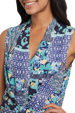 We love this easy sleeveless blouse in the softest printed woven fabric. Gorgeous blues, yellow, green and white colors come together to create an eye appealing medley of color while a front tie defines the waist.  Dress this top up for work or wear casually while running errands, this stunning flowy top is a must have in your wardrobe.  Color- Lagoon; white, blues, green, yellow. Pop-over V-neck. Flowy fit. Faux front tie.