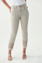 Load image into Gallery viewer, Pictures just do not do this gorgeous jean by Joseph Ribkoff justice!  A beautiful tan color fabric is enhanced with a sparkling lattice design in silver crystals mid-calf. Bottom of each leg is slightly frayed to give just the right amount of edge.  A stunning crop jean to dress up or wear casually.  Either way, you will be receiving compliments when you wear our Larisa!  Color-Denim Sand.  Silver buttons and hardware.  Silver crystals.
