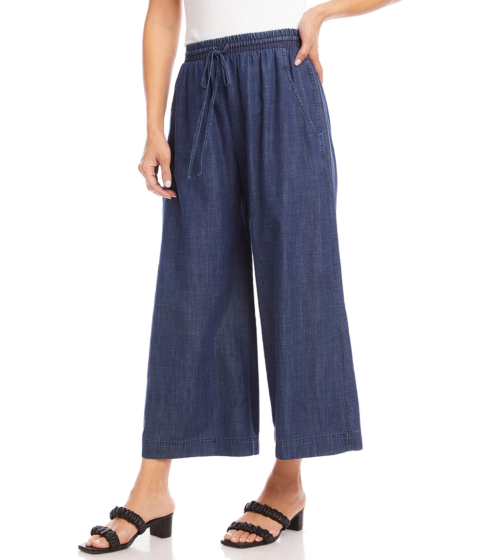 What is better than a pair of breezy, comfortable wide leg pant to keep you cool and comfortable during those warm, sunny days? Our Whitney Wide Leg Pant is just that, a breezy, roomy, Tencel cotton pant that features an elasticized waistband, functional front pockets and a front tie detail.  A versatile bottom to wear casually or dressed up. Color- Denim blue. Elasticized waistband. Ankle length.