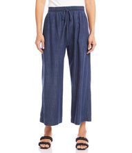 Load image into Gallery viewer, What is better than a pair of breezy, comfortable wide leg pant to keep you cool and comfortable during those warm, sunny days? Our Whitney Wide Leg Pant is just that, a breezy, roomy, Tencel cotton pant that features an elasticized waistband, functional front pockets and a front tie detail.  A versatile bottom to wear casually or dressed up. Color- Denim blue. Elasticized waistband. Ankle length.

