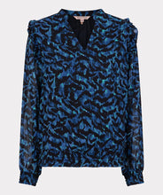 Load image into Gallery viewer, A gorgeous pop of all over blue in an animal print is striking on the Wilda Wild Celebration Blouse. The Wilda has a round neckline, decorative ruffles on the shoulders and smocked cuffs. Pair with a pair of faux leather or black pants or your favorite denim and boots and you&#39;ll be a fashionista!
