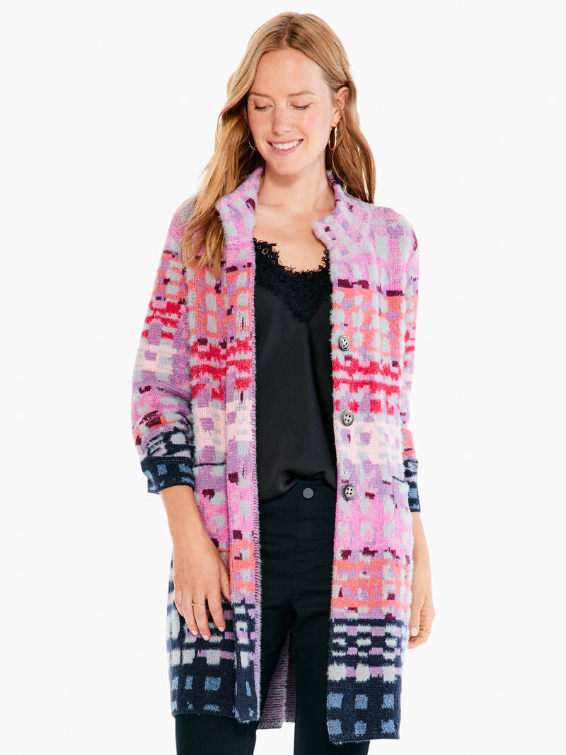 We love this dual-purpose coat/cardigan and the amazing pops of color that it offers.  Our Willa coatigan can be worn as a cardigan or a coat, depending on the day and your mood. Full of novelty yarns with poppy textures (we love the grey yarn's extra fuzziness) this long party coatigan is perfect for cold-weather gatherings. Our Willa has a button front, mock collar, and a surprisingly soft, and entirely welcome, drapey feel.